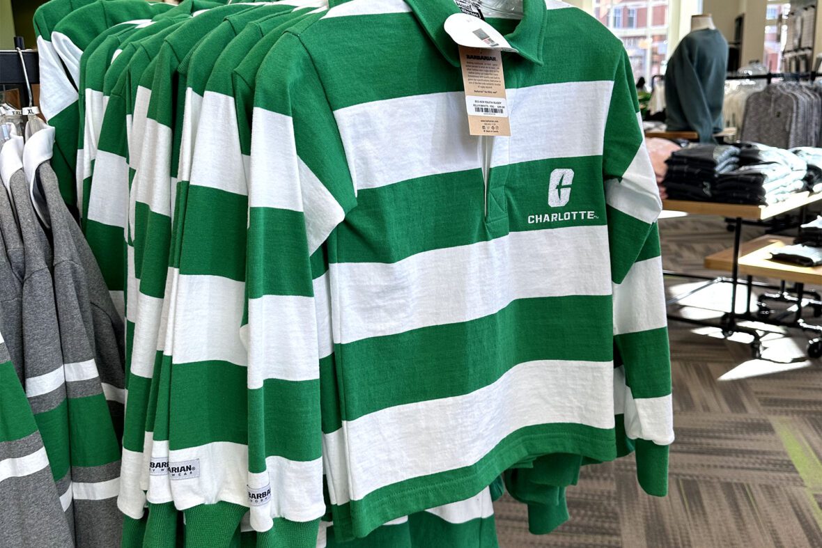 Green and white striped rugby shirts on display in a store.