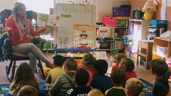 Elementary School teacher teaching a group of students