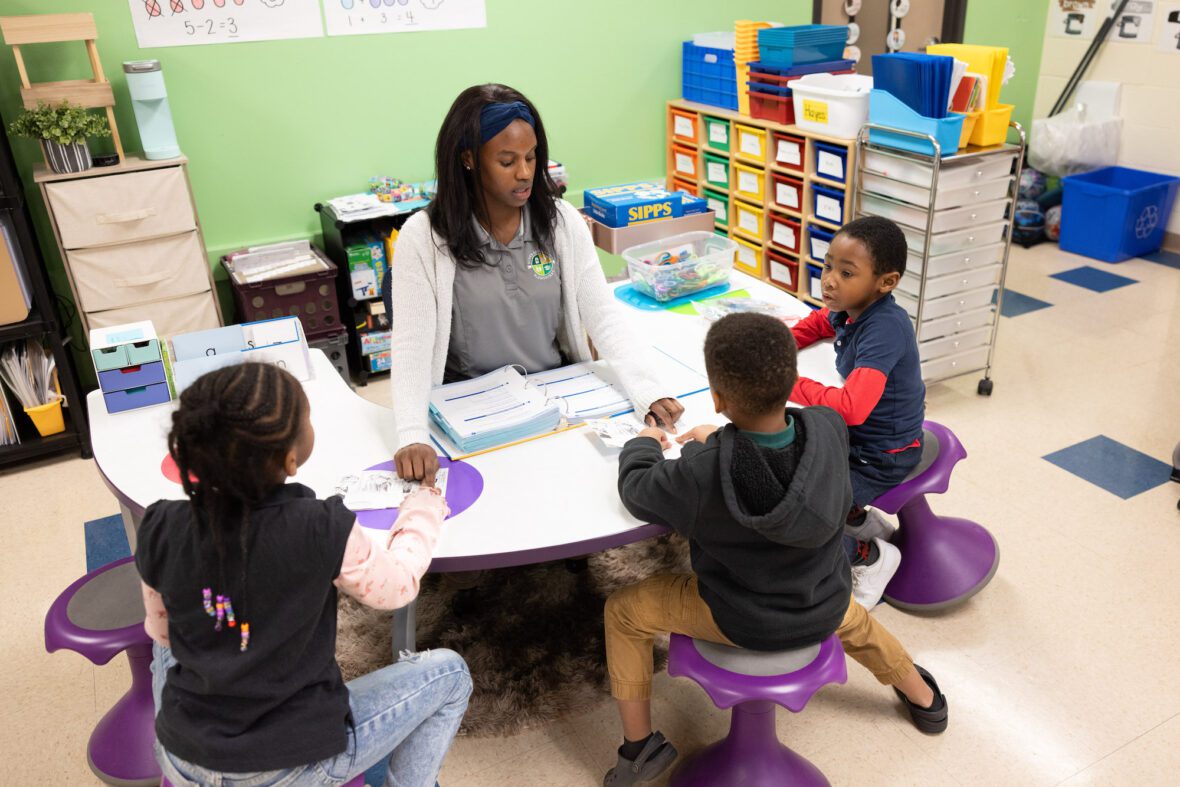 UNC Charlotte student teacher with three students